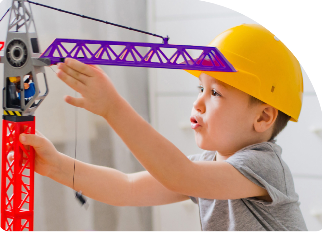 Boy playing with toy crane